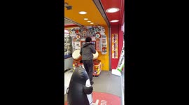 Japanese salaryman rocks out on arcade drum machine in hilarious manner