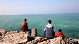 Palestinians enjoy on the sea port of Gaza City. Weather today in Palestine is clear and warm in daytime with a further rise in temperature