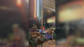 Thai chef cooks up spicy dish with flames licking the air