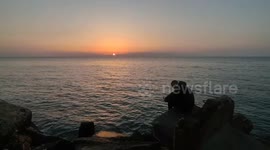 The moment of sunset on the shore of the Gaza sea