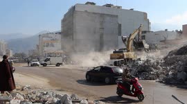 Rescuers dig under the rubble after the deadly earthquake in Iskenderun, Turkey