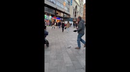 Curious little boy is mesmerised by street artist's performance of 'Blinding Lights' by The Weeknd