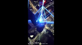 Crazy French man dangles off a crane in Central London upside down