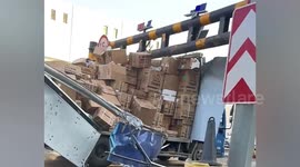 Cargo truck disintegrates after crashing into overhead barrier in China