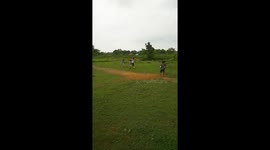 football playing village boys in green field ODISHA . Friendship foot ball match
