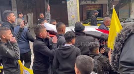 Palestinians carry the body of Muntaser al-Shawwa was shot on February 8 during his funeral at the Balata refugee camp, in the West Bank city of Nablus