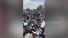Locals clamber through astonishing mountain of used clothes in Thailand