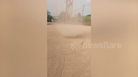 Dust devil tornado swirls perilously close to locals