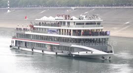 Ship Carries Tourists Through The Gezhouba Section of the Yangtze River in Yichang, China