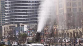 A Remote Spray Truck Drops Water And Dusts dust Along A Street in Yichang, China