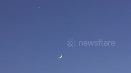 Jupiter and Venus in conjunction with moon seen clearly above St Petersburg, Russia