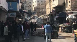 Palestinians clash with Israeli forces during a military raid in the West Bank city of Nablus