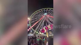 Fearless fairground worker climbs 50ft high Ferris wheel without safety gear