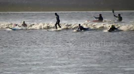 Surfers ride the wave of the 4* Severn Bore at Newnham-on-Severn