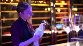 Bar waitress cleaning glass at Hakkasan Mayfair, London, UK