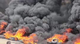 Palestinian youths burn tires during a protest near the Israel-Gaza border