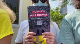 Protesters hold placards on first anniversary of Russia-Ukraine conflict