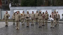 Ukrainian military band plays at Lviv cemetery service marking war's anniversary