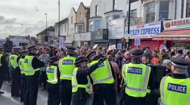 Police separate protesters and supporters during drag queen storytelling event at Honor Oak Pub, London