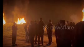 Palestinians burn tires and protest near the border fence between Israel and the Gaza Strip