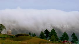 Spectacular 'cloud waterfall' streams over mountains in the Philippines