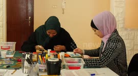 Palestinian architects and artists paint artwork using mosaic stones to preserve the Palestinian heritage
