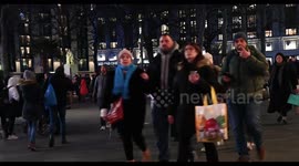 Groups of people walking through Leicester Square, London, United Kingdom