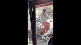 Food stall cooking while driving in Cambodia