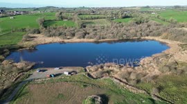 Drone footage flying over a lake in northern Ireland