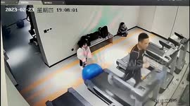 Man falls off treadmill after girl pushes yoga ball under machine