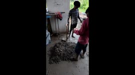 Handmade cement concrete and water mixing  in India . life of labour