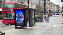 Forensic officers work at the scene of a stabbing on Oxford a street in Central Londo