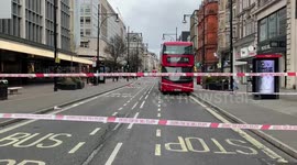 Forensic officers work at the scene of a stabbing on Oxford Street in Central London