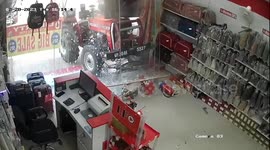 Dramatic footage shows tractor starting on its own, breaking into showroom