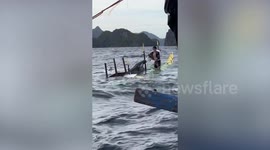 Passing boat rescues tourists who fell off capsized ship