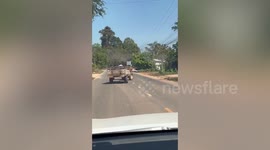 Tractor with wonky wheel crawls along road