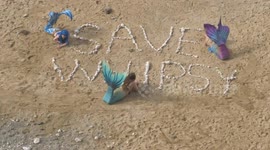 Protesters dress as mermaids in act against holiday homes being built on Cornwall beach