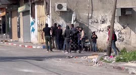 Palestinian protesters hurl stones towards Israeli forces during clashes following the funeral of youth Mohammad Slim, 15, shot dead by Israeli troops a day earlier, in the village of Azzun in the West Bank