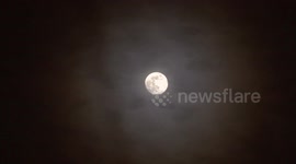 Mysterious parallel lines form as halo of clouds surround the moon