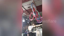 Tires swing from shop ceiling during Philippines earthquake