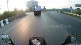 Election campaign posters fly out of pickup truck and narrowly misses oncoming vehicles