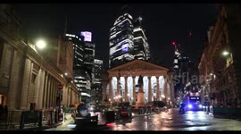 Multiple buses driving through the City of London right past the Bank of England, London, United Kingdom.mp4