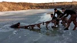 Heroic Chinese soldiers use makeshift rope to save villager trapped in frozen river