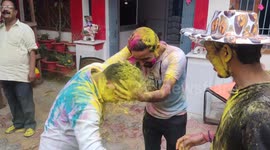 Holi: Young people throw buckets of colorful paint at each other and get messy