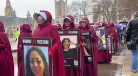 Demonstrators dress as handmaids to raise awareness on struggle of Iranian women