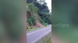 Motorcycle rider hit by landslide crashing onto road after Philippines earthquake