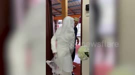 Affectionate uncle carries niece across flooded street for her wedding in Malaysia