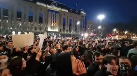 People chant outside the parliament in Tbilisi, Georgia