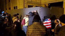 Protesters make noise at the back entrance of the parliament in Tbilisi, Georgia