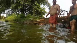 Two Indian village young man jumping on pond in slow motion
